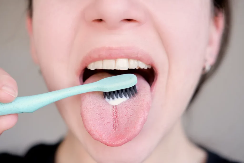 should you brush your tongue or use a tongue scraper