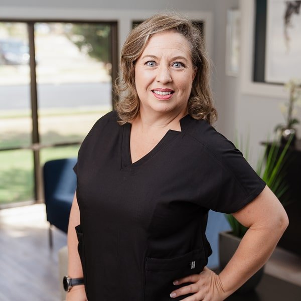 A woman is smiling at brush365 dental studio