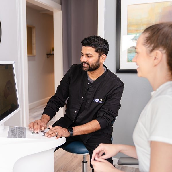 Dental professional at work with his smiling patient - both smiling