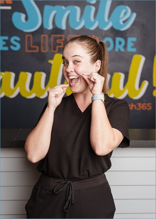 Dental specialist showcasing how to floss