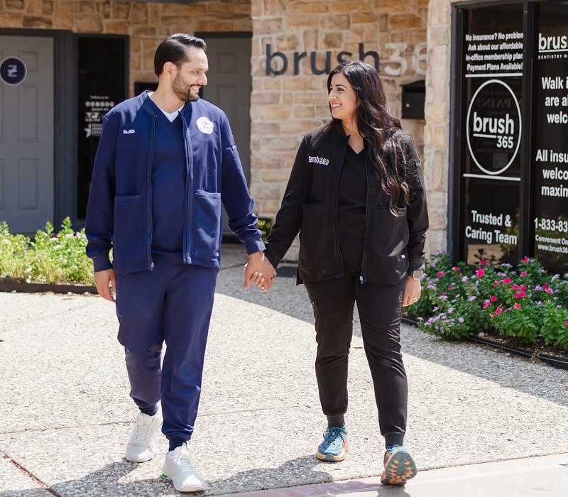 Dentists holding hands and having a good time outside brush365 dental studio