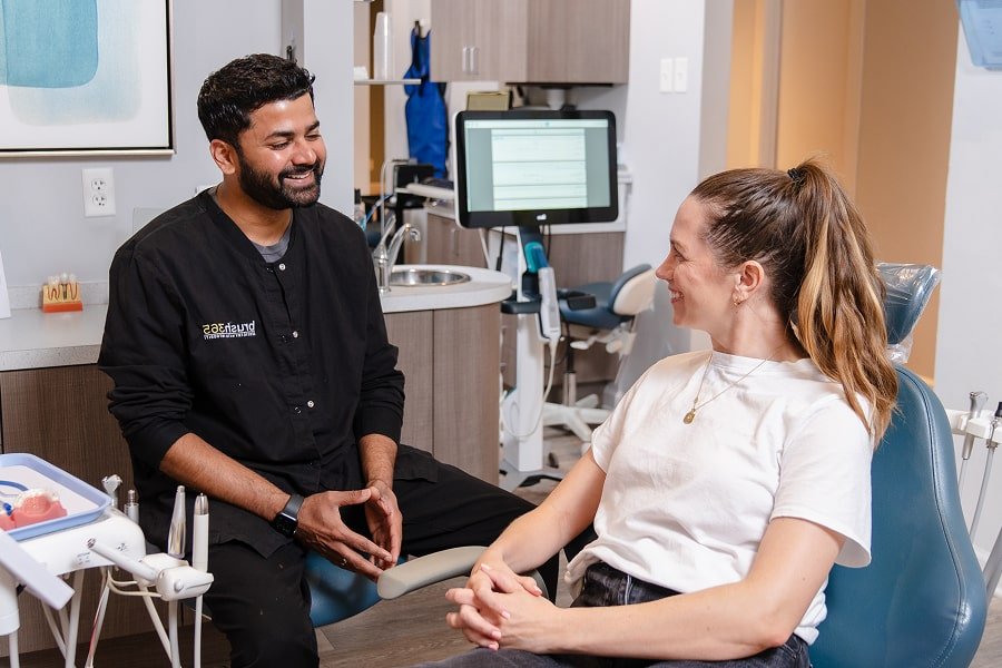 Dr. Akshay Bangale is smiling with his patient at brush365