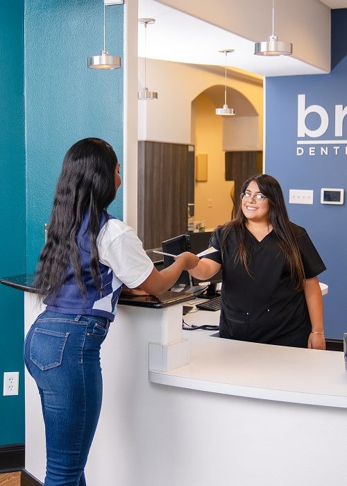 Receptionist is greeting a patient