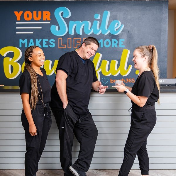 brush365 dental team is happily smiling and having fun