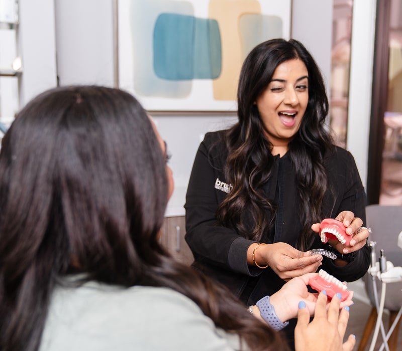 brush365 dentist showcasing clear aligners and smiling