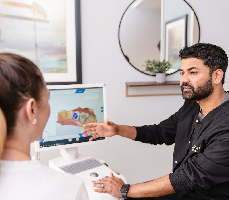 brush365 dentist with a patient smiling in a dental room