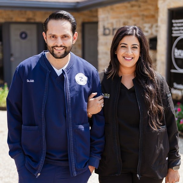 brush365 dentists are smiling in front of dental office