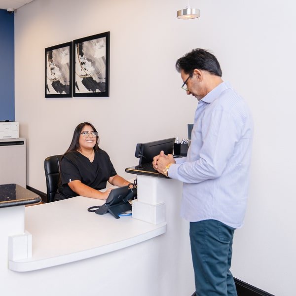 brush365 front desk professional is grating patient with a warm smile