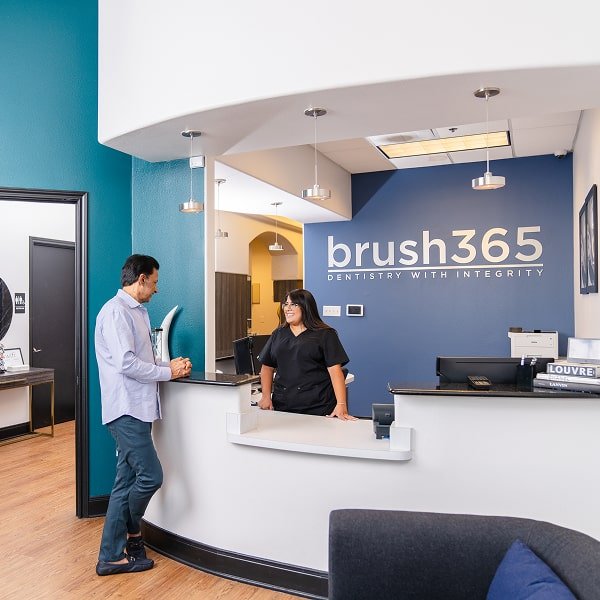brush365 front desk with smiling people