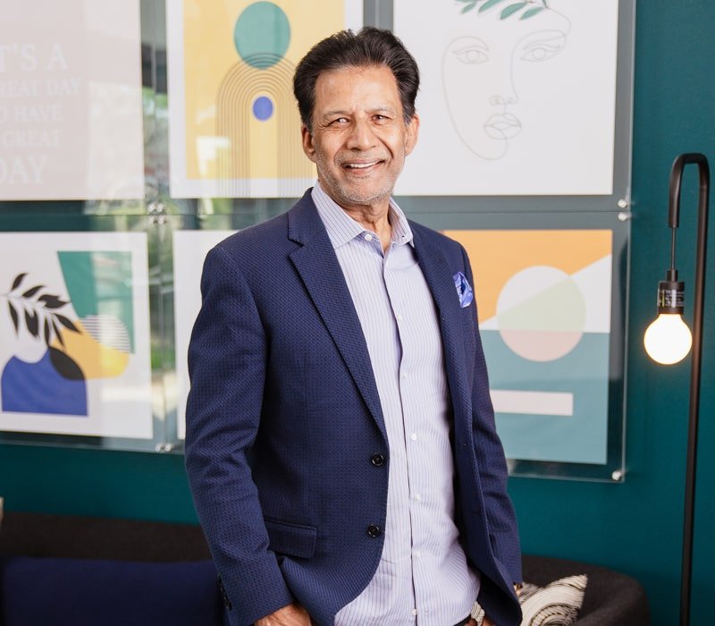 A man in a glasses is smiling