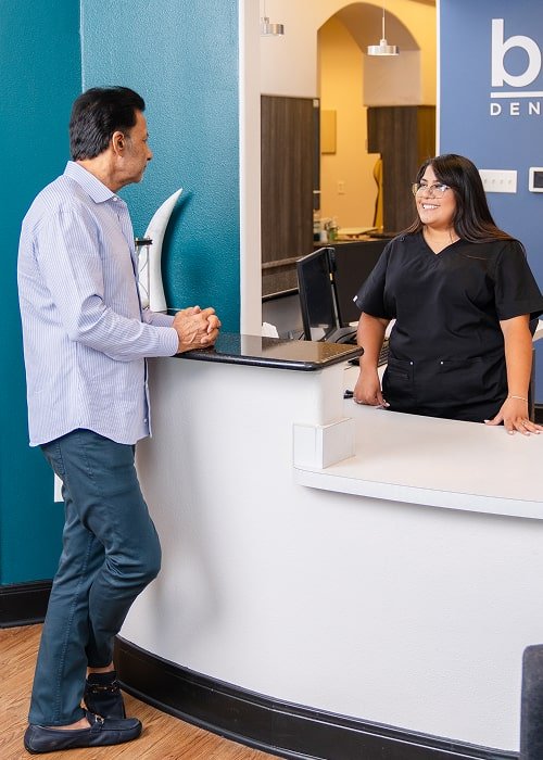 A man talking to a brush365 receptionist