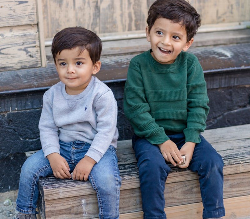 Two kids sitting alongside each other