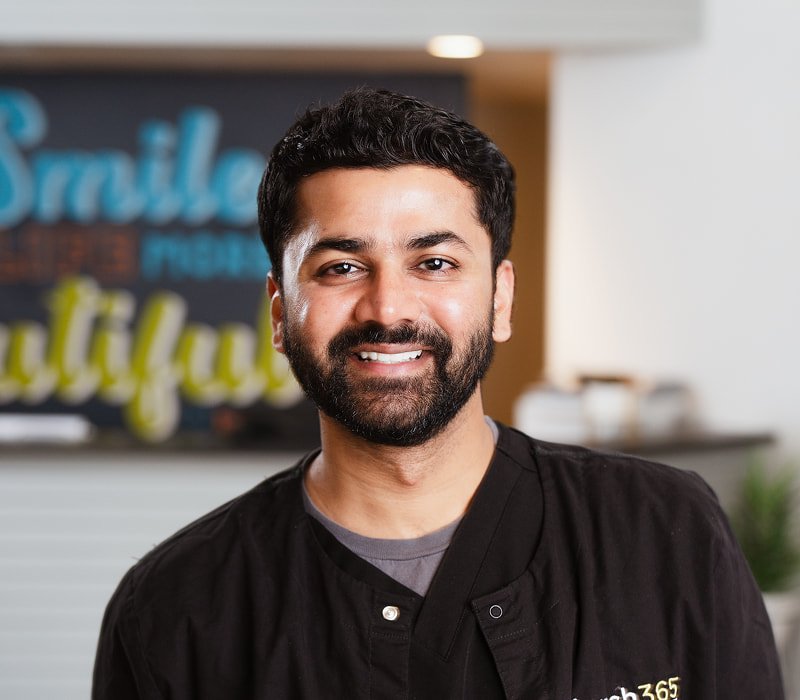 brush365 team member in his uniform smiling