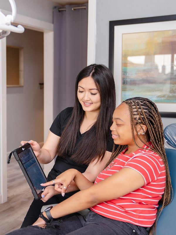 A brush365 team member showing a patient a tablet