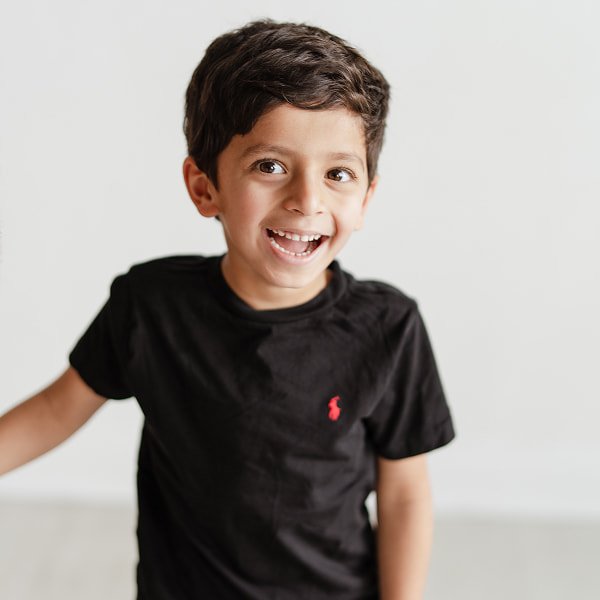 Kid in a black shirt smiling