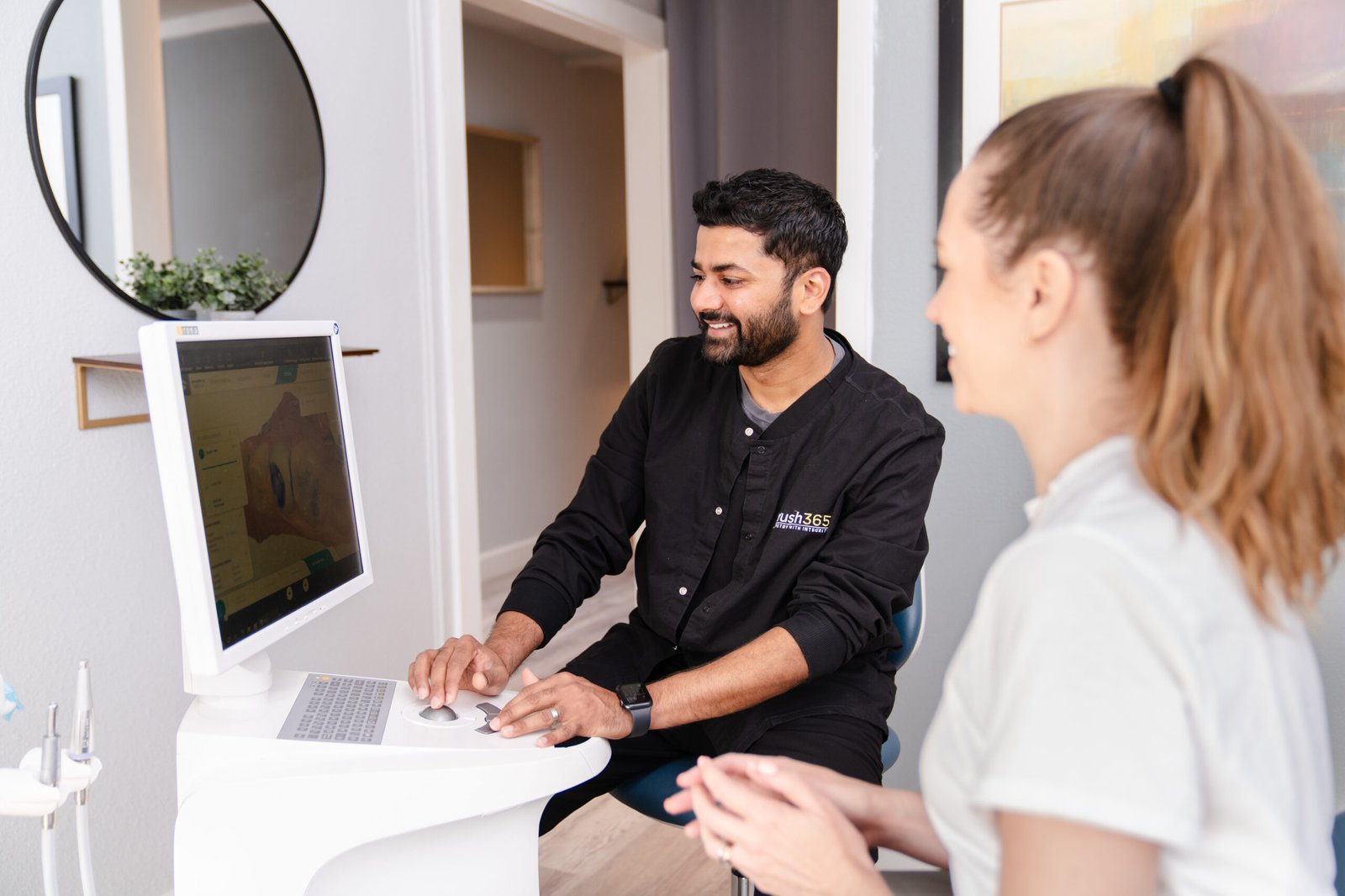 Joyful brush365 patient is smiling while discussing her options with dental professional