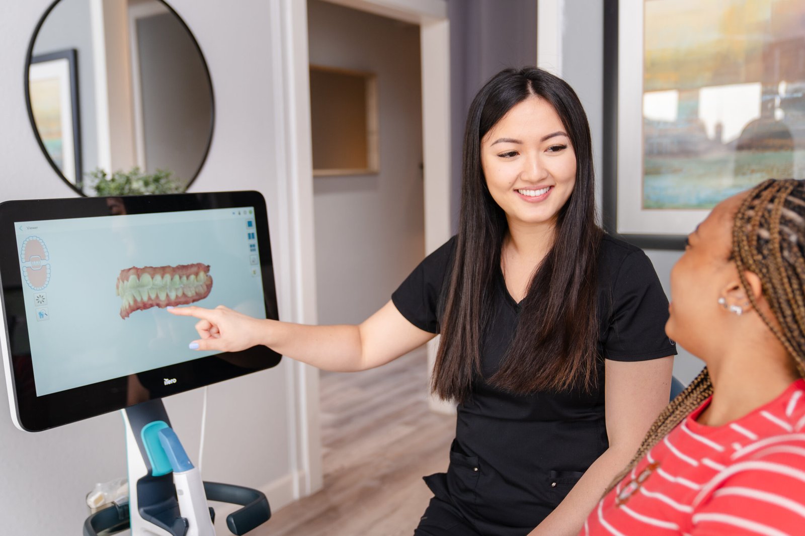 brush365 front desk is smiling and greeting smiling patient